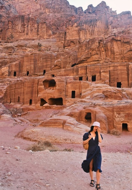 Standing in front of caves in Petra