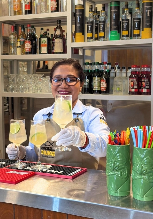 Waitress with drinks at bar