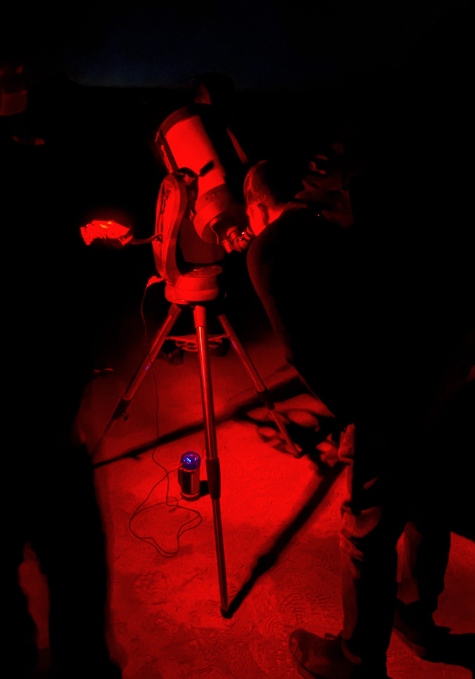 Looking through a telescope on stargazing tour